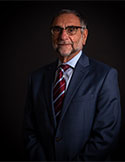 Daan Braveman wearing glasses and suit and tie